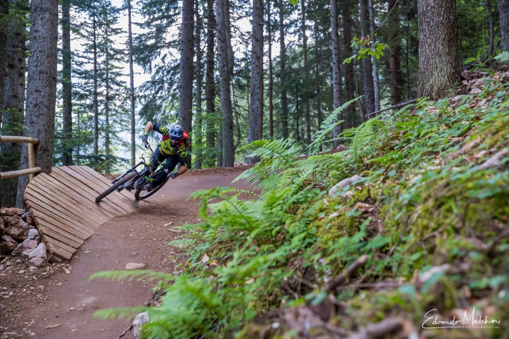 A MTB rider approaching a corner in the Dolomiti Paganella Bike Park